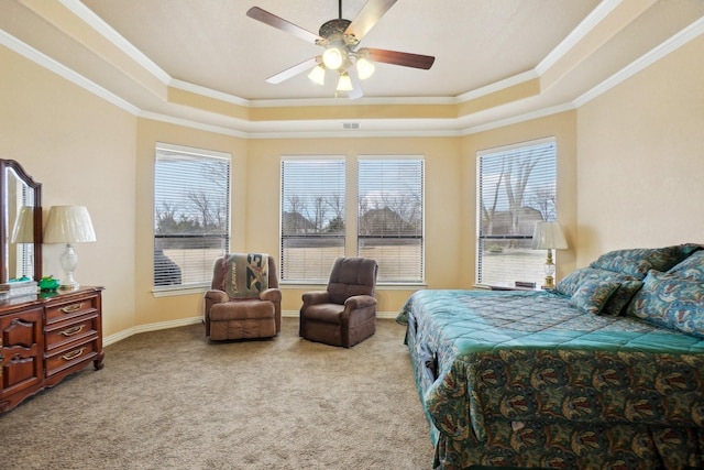 carpeted bedroom with ceiling fan, crown molding, and a tray ceiling