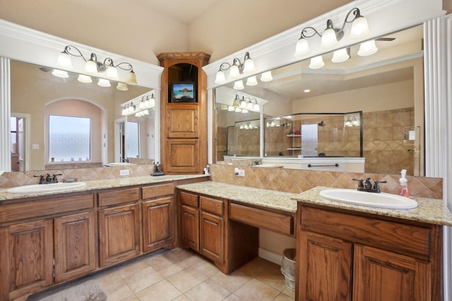 bathroom featuring vanity, decorative backsplash, tile patterned floors, and tiled shower