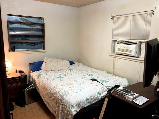 bedroom featuring cooling unit and parquet floors