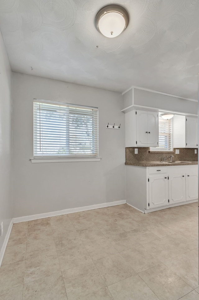 kitchen featuring white cabinets and tasteful backsplash