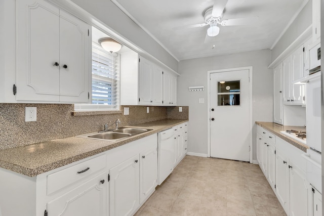 kitchen featuring white appliances, tasteful backsplash, white cabinets, ceiling fan, and sink