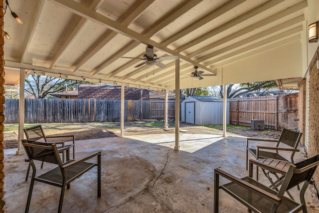 view of patio featuring ceiling fan and a storage unit