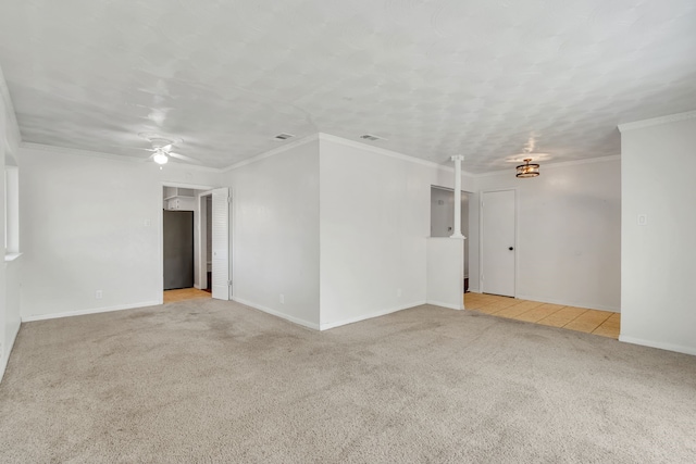 carpeted spare room featuring ornamental molding and ceiling fan