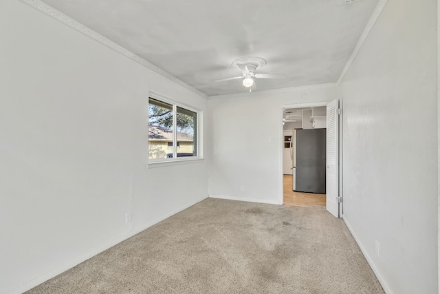 empty room with light carpet, ceiling fan, and crown molding