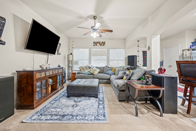 carpeted living room with ceiling fan