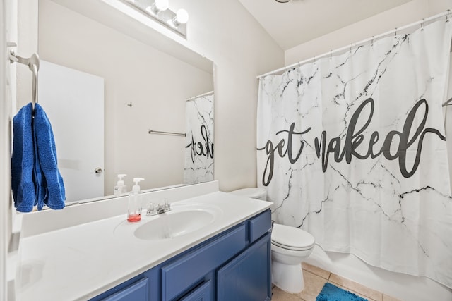 full bathroom featuring toilet, vanity, tile patterned floors, and shower / bath combo with shower curtain