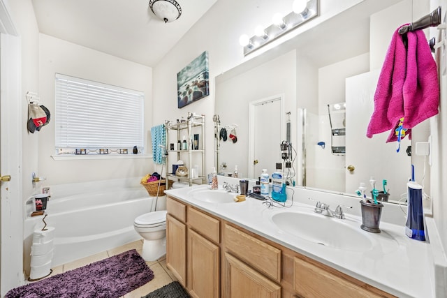 bathroom featuring toilet, a tub, tile patterned floors, and vanity