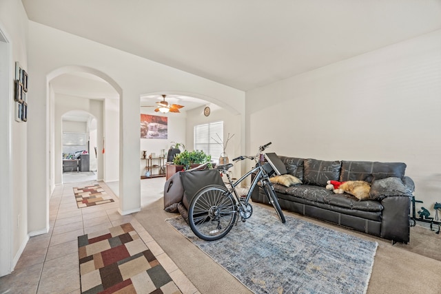 tiled living room with ceiling fan