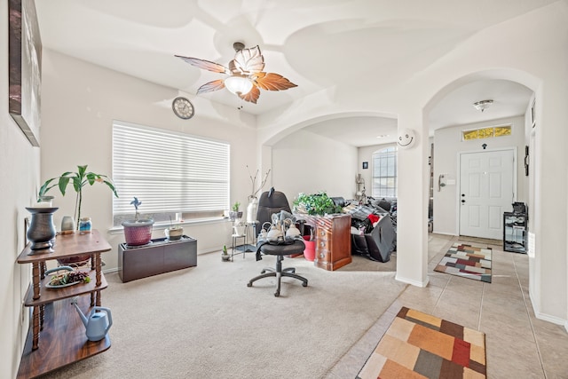 tiled office space featuring ceiling fan