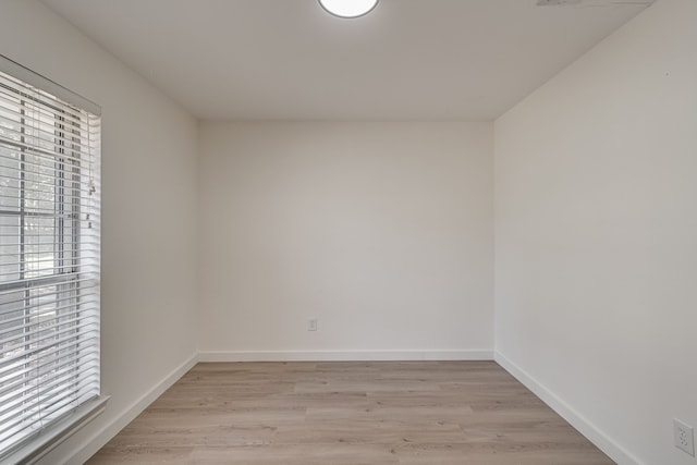 spare room with light hardwood / wood-style flooring and a healthy amount of sunlight