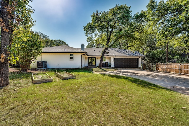 ranch-style house with a garage, central AC, and a front yard