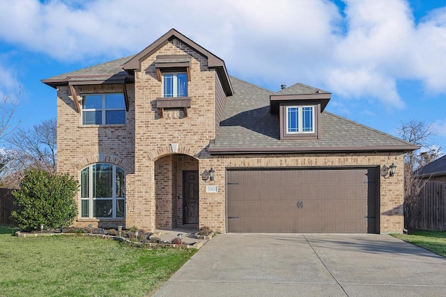 view of front of house featuring a front lawn and a garage