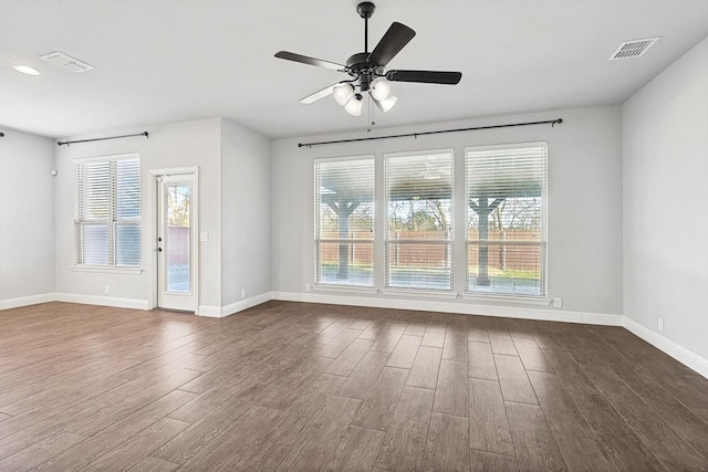 unfurnished room with ceiling fan and dark wood-type flooring