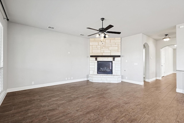 unfurnished living room featuring a fireplace, ceiling fan, and wood-type flooring