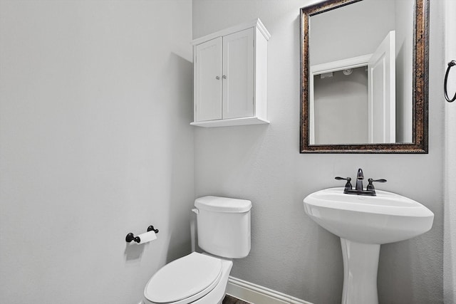 bathroom featuring toilet and sink