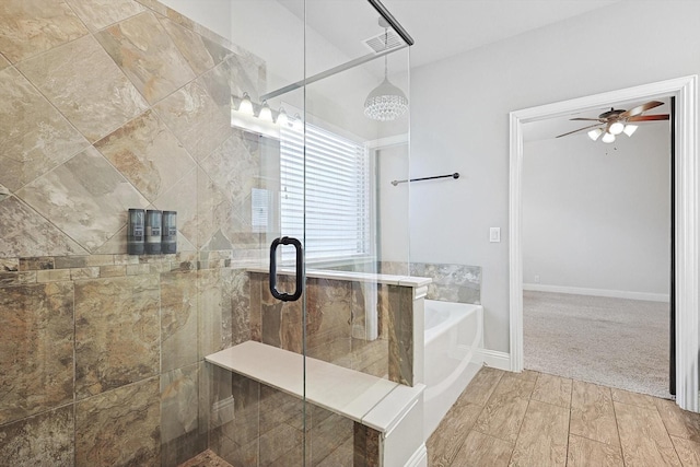 bathroom featuring ceiling fan and separate shower and tub