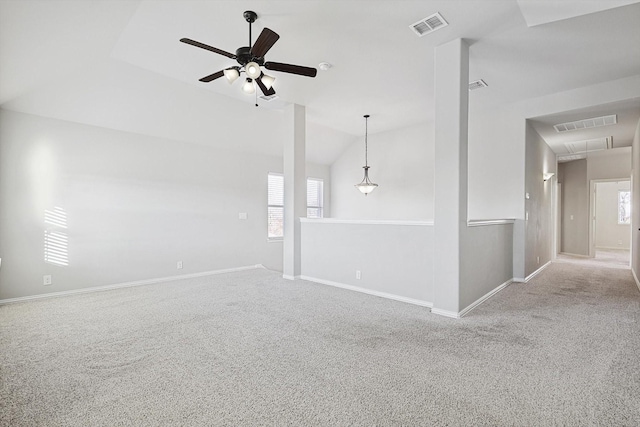 carpeted spare room featuring ceiling fan and lofted ceiling