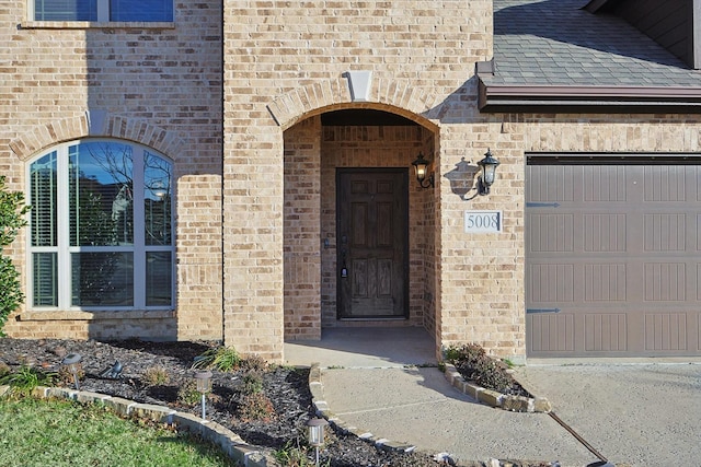 doorway to property with a garage