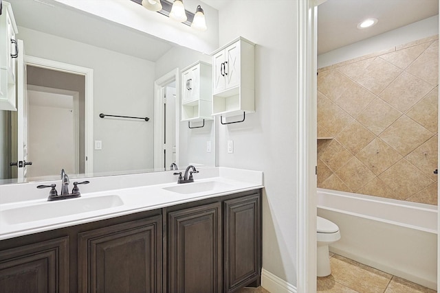 full bathroom featuring toilet, vanity, and tiled shower / bath combo