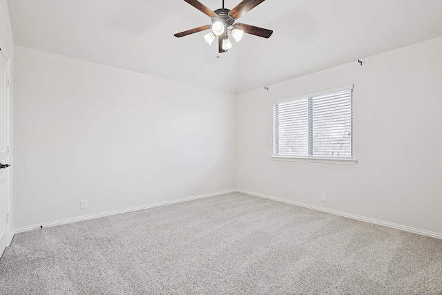 spare room with vaulted ceiling, ceiling fan, and carpet flooring