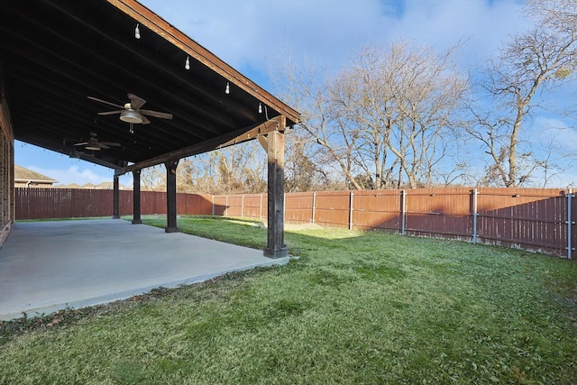 view of yard with a patio area and ceiling fan