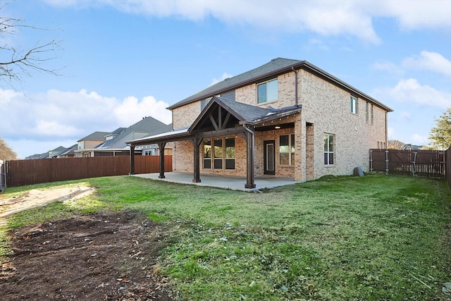 rear view of house featuring a yard and a patio