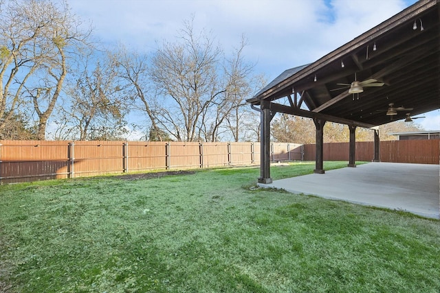 view of yard with ceiling fan and a patio area