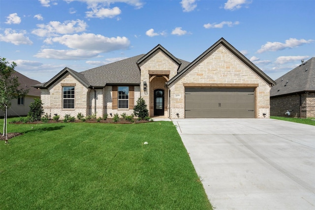 french country inspired facade featuring a garage and a front lawn