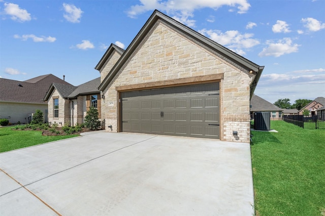 view of front of property featuring central AC, a front lawn, and a garage