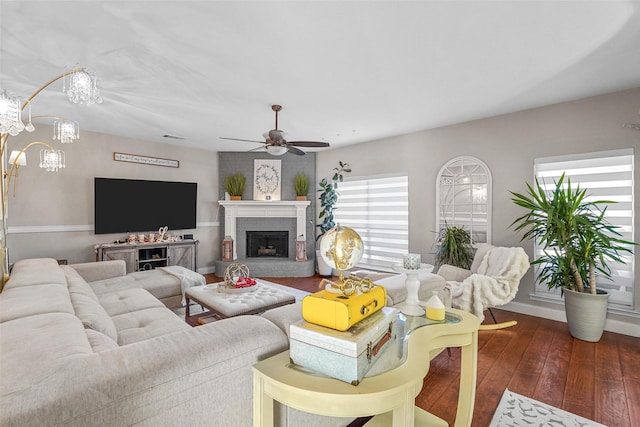 living room featuring a brick fireplace, ceiling fan, and dark hardwood / wood-style floors