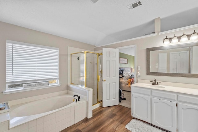 bathroom featuring separate shower and tub, vaulted ceiling, vanity, and wood-type flooring