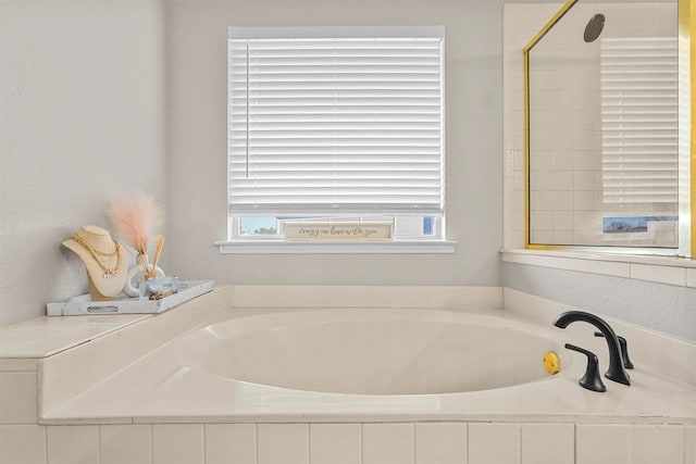 bathroom featuring tiled tub