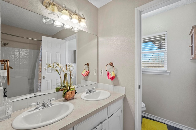 bathroom featuring a shower with curtain, vanity, and toilet