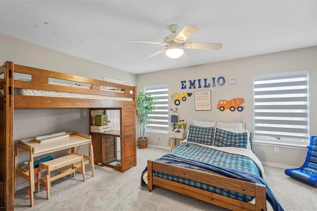 carpeted bedroom featuring ceiling fan and multiple windows