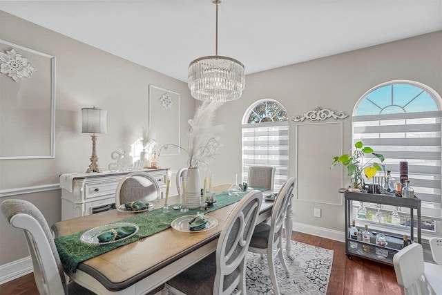 dining room featuring dark wood-type flooring and an inviting chandelier