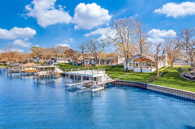 exterior space with a yard, a dock, and a water view