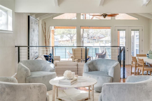 living room featuring french doors, ceiling fan, lofted ceiling with beams, and wood-type flooring