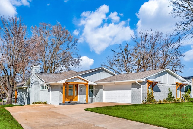 view of front facade with a front yard and a garage