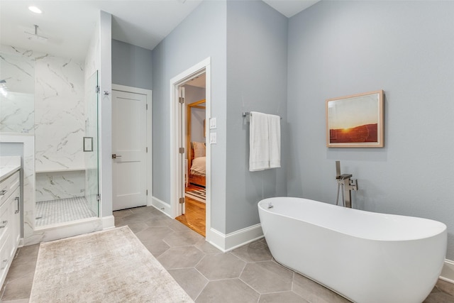 bathroom with shower with separate bathtub, tile patterned floors, and vanity