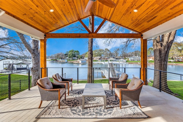 view of patio / terrace with ceiling fan, a water view, and a gazebo