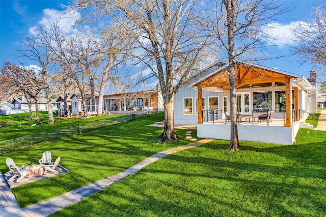 view of yard featuring ceiling fan, a fire pit, and a patio area