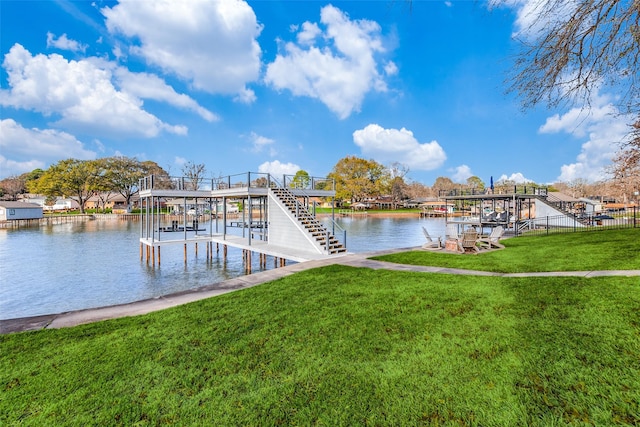 dock area with a yard and a water view