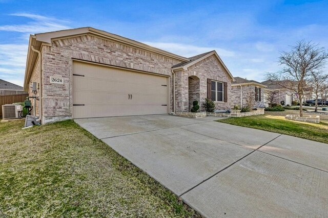 ranch-style home featuring central AC, a front lawn, and a garage