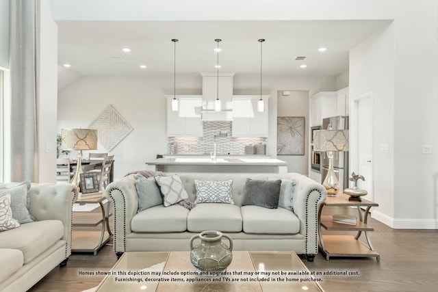 living room featuring sink, lofted ceiling, and wood-type flooring