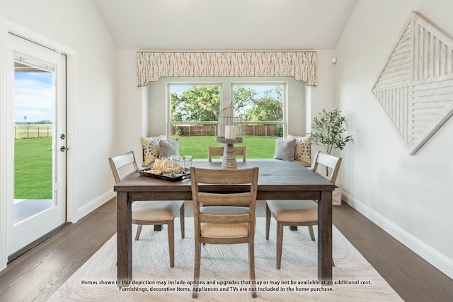 dining area with vaulted ceiling and dark hardwood / wood-style floors