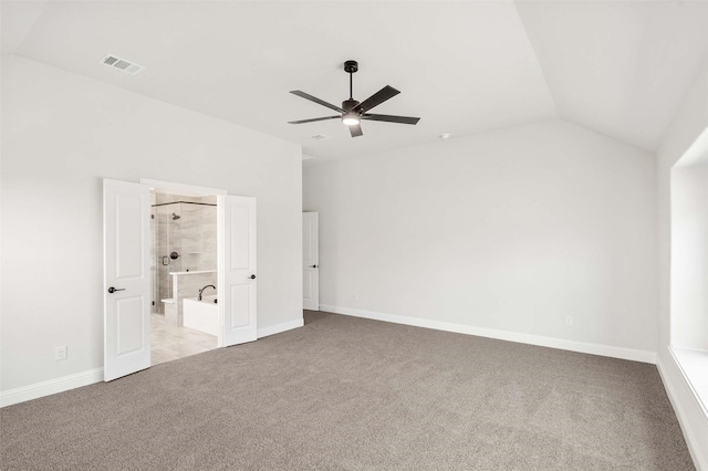 unfurnished bedroom with vaulted ceiling, carpet flooring, visible vents, and baseboards