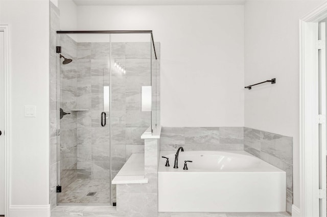 full bathroom featuring a garden tub and a stall shower