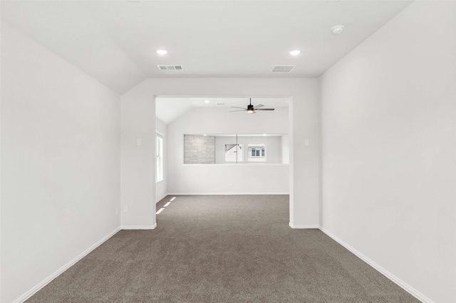 unfurnished living room with vaulted ceiling, visible vents, carpet floors, and ceiling fan