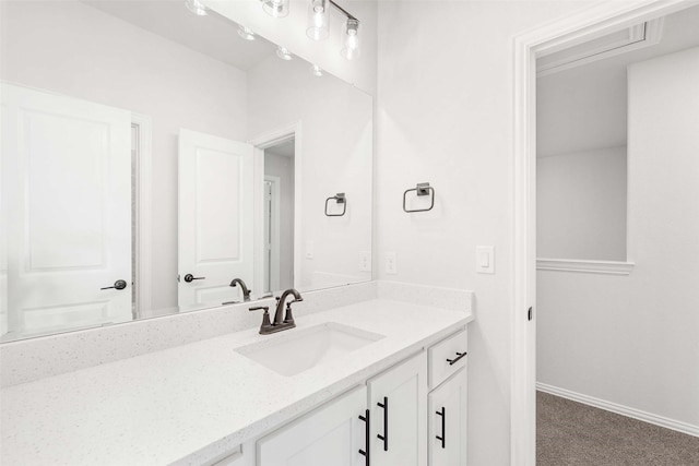 bathroom featuring baseboards and vanity