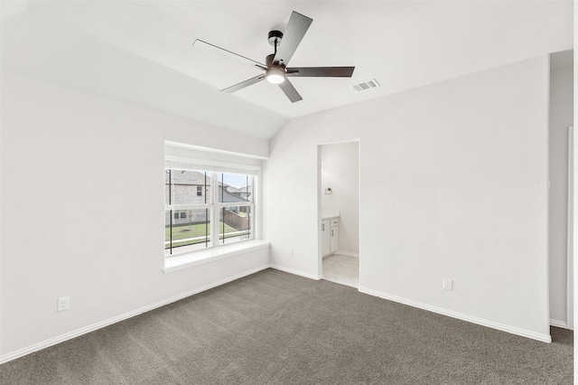 unfurnished bedroom featuring carpet floors, visible vents, lofted ceiling, and baseboards
